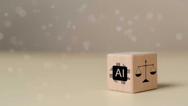 © The KonG - stock.adobe.com Wooden block featuring AI chip icon and legal scale