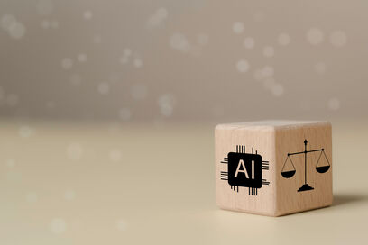 © The KonG - stock.adobe.com Wooden block featuring AI chip icon and legal scale